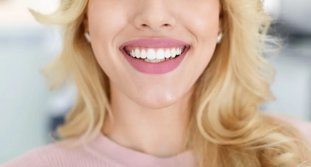 Patient with a beautiful smile after Damon Braces treatment